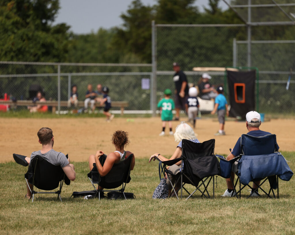 Family together at a baseball field, symbolizing unity, love, and the fellowship that defines the Bibles and Baseball community.
