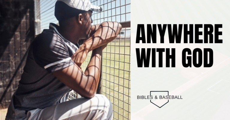 Baseball player sitting in the dugout, gazing toward the field, reflecting on faith and finding peace anywhere with God.
