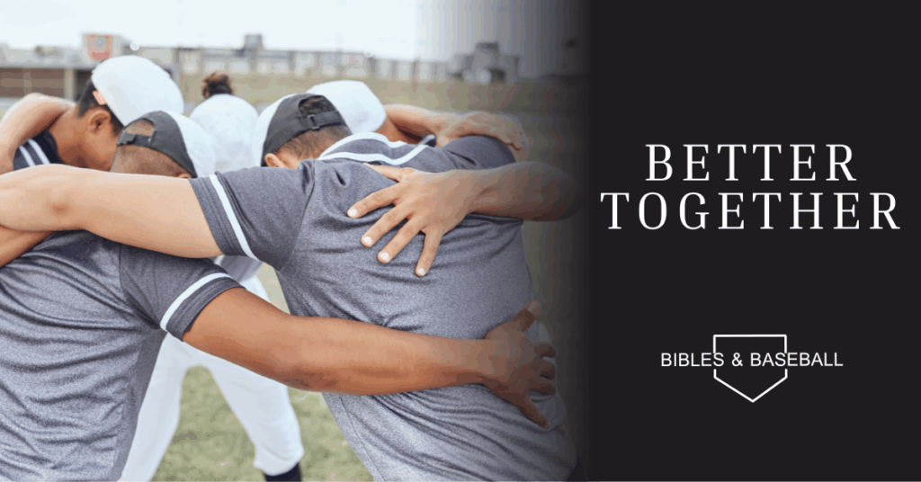 Baseball players standing in a tight huddle with arms around each other, symbolizing unity, teamwork, and fellowship.