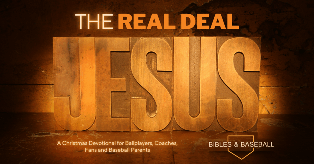 The words “The Real Deal Jesus” displayed in bold wooden lettering, symbolizing authenticity, fulfillment of prophecy, and faith during a Christmas devotional for baseball families.