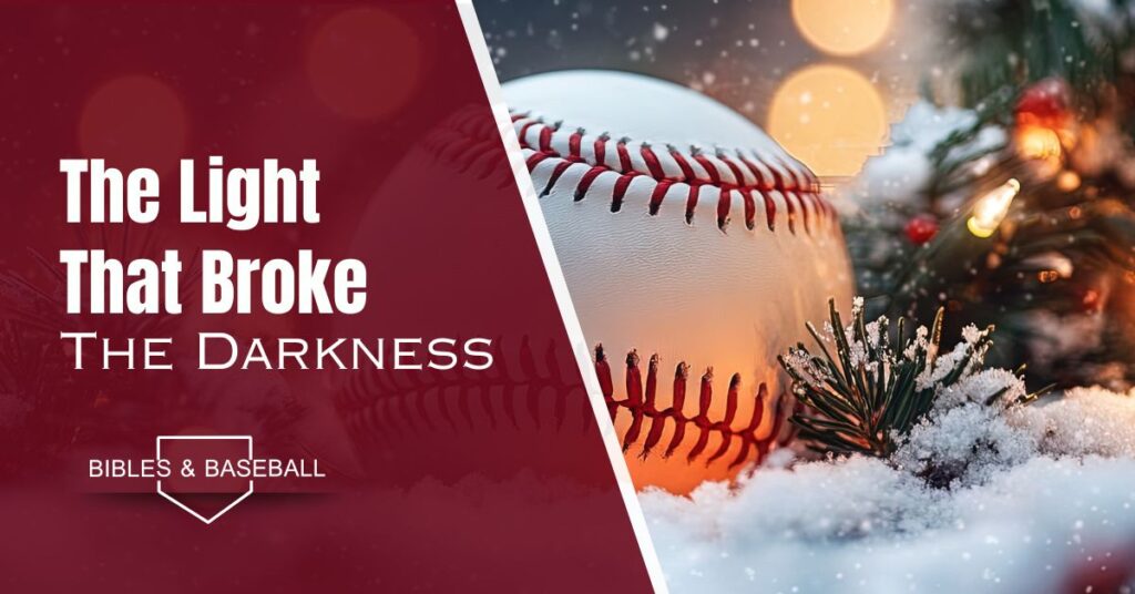 A baseball resting in snowy pine branches beside glowing Christmas lights, symbolizing Christ as the Light that breaks the darkness.