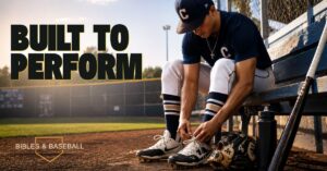 High school baseball player sits on a dugout bench at sunset tying his cleats before a game. His glove, bat, and water bottle rest beside him as he prepares on the field, symbolizing discipline, preparation, and stewardship.